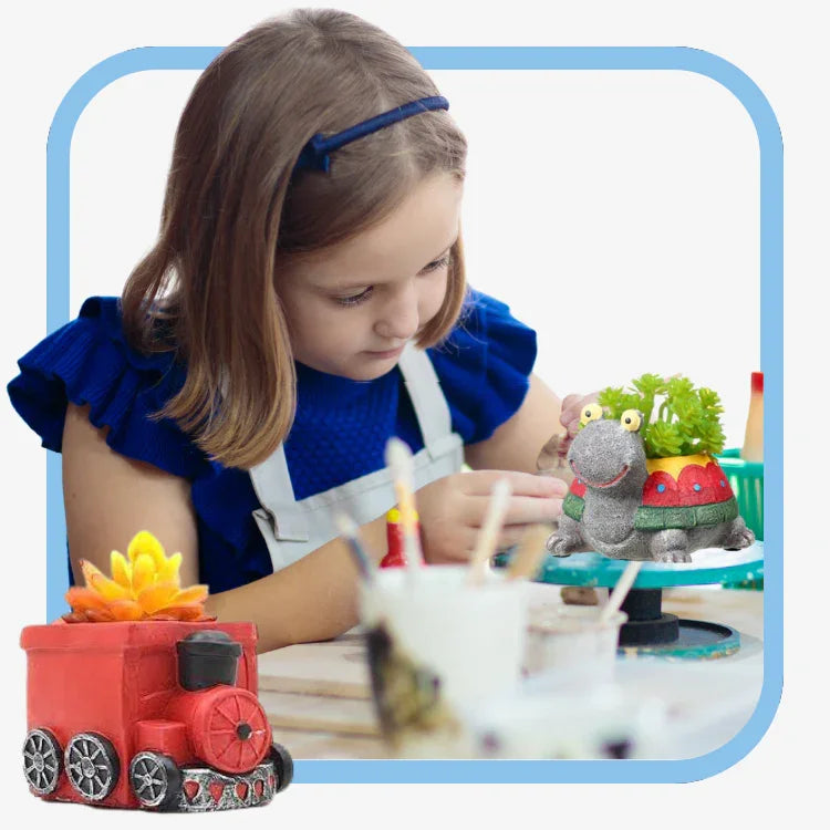 Young girl crafting colorful elephant and train-shaped succulent planters on a table