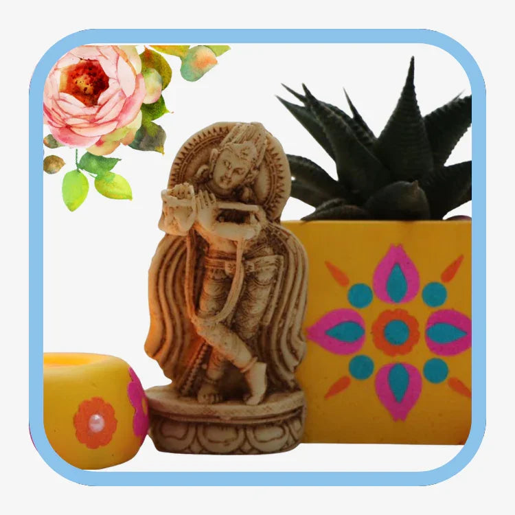 Small carved Krishna statue playing flute with yellow floral pot and succulent plant